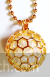 Circular shaped golden pendant with long chain